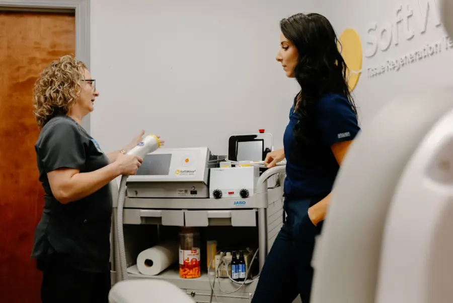 Circle Chiropractic team member preparing the SoftWave tissue regeneration therapy device