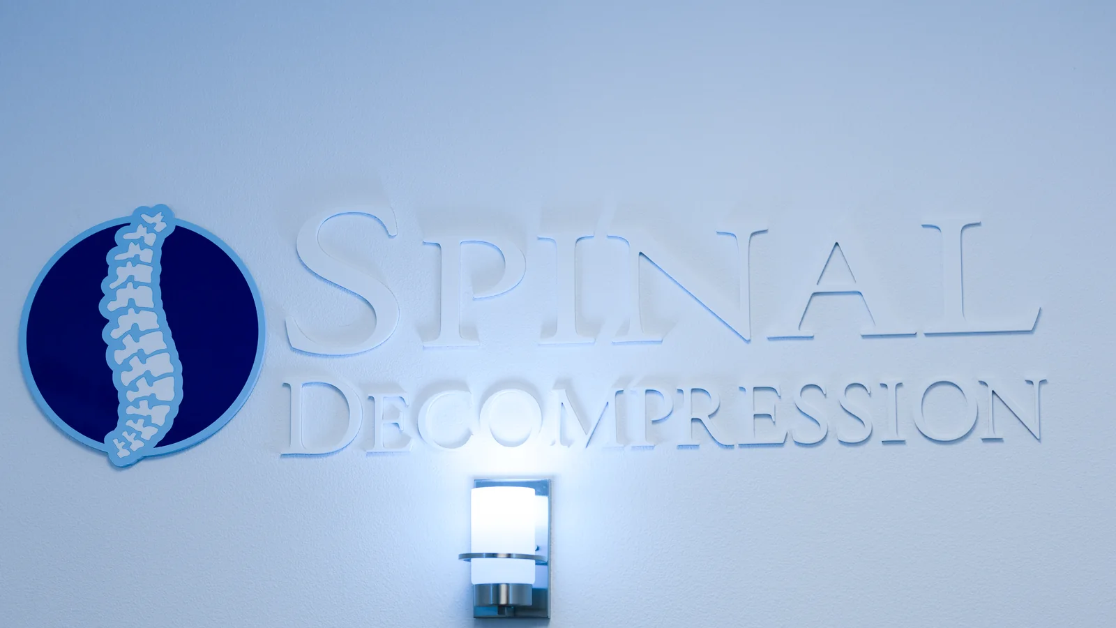 Dr. Ben Duke standing beside the spinal decompression table at Circle Chiropractic