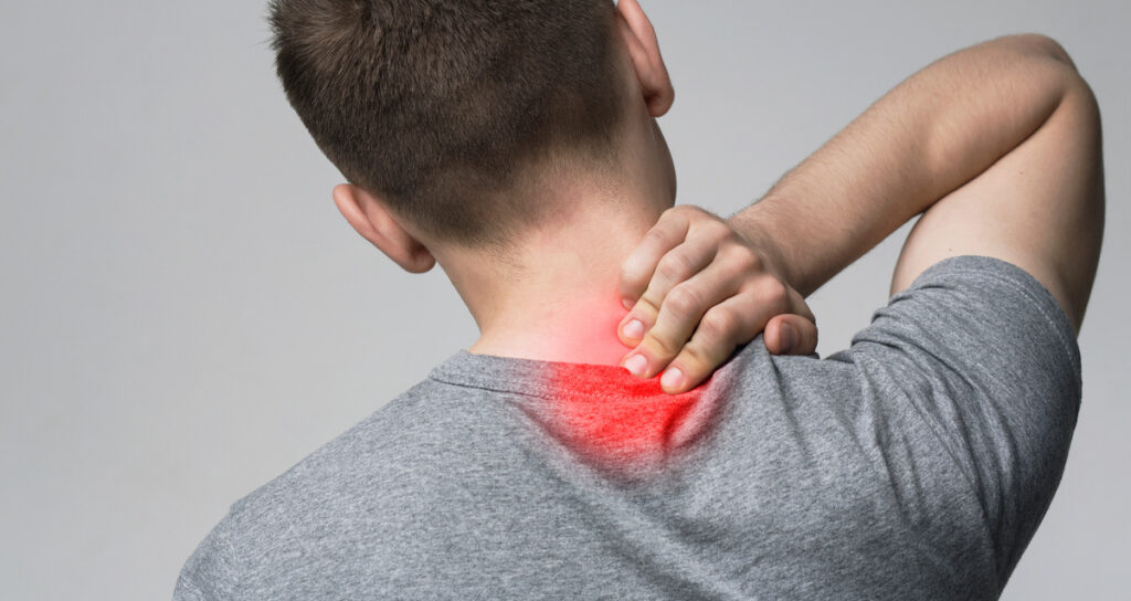 young man massaging his sore neck, back view
